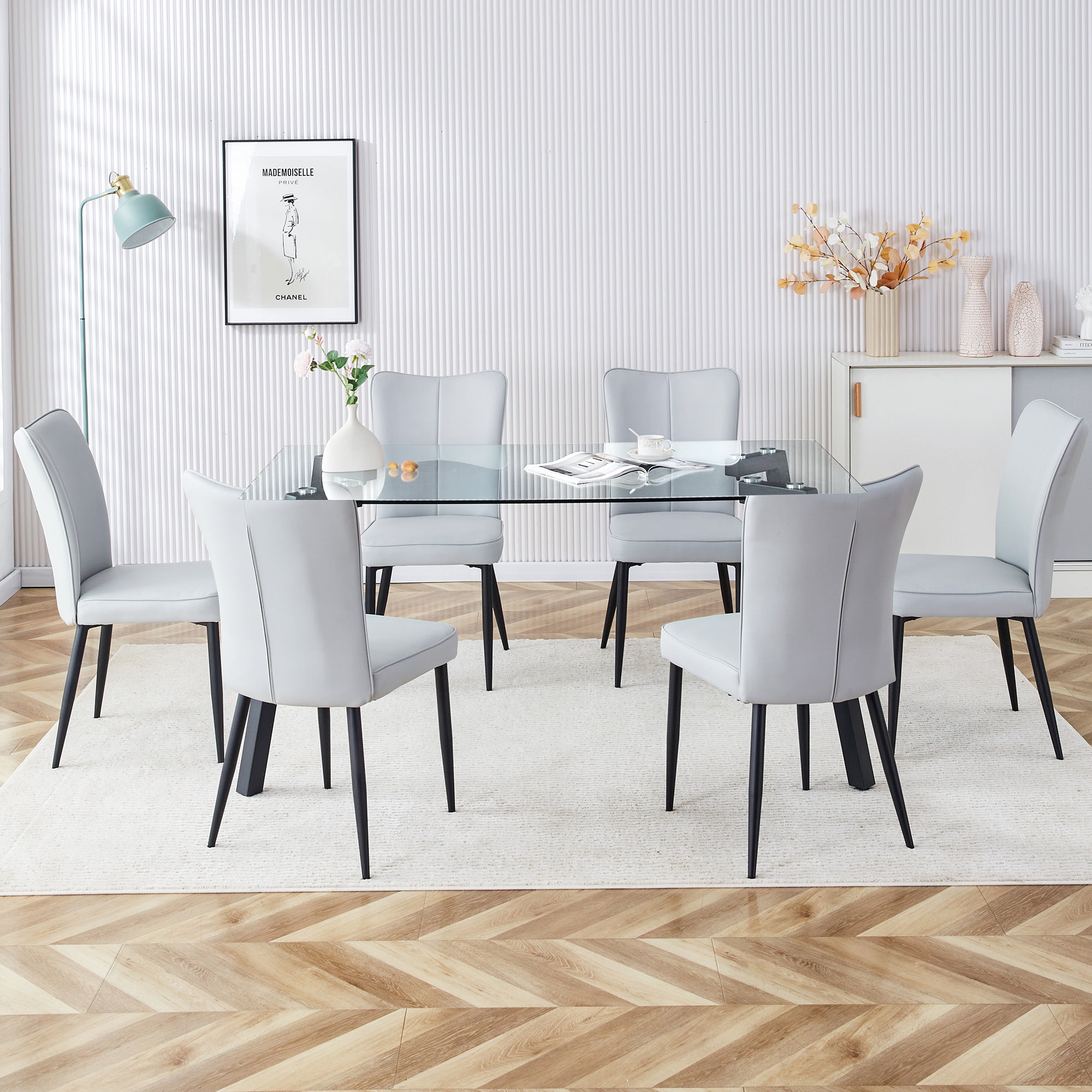 Table and chair set. 1 table and 6 light grey chairs. Glass dining table with 0.31-inch tempered glass tabletop and black coated metal legs. Equipped with light grey PU chairs 1123 008